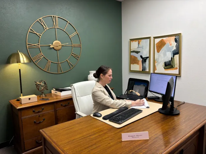 Maggie Mauer, Attorney at Law, at her desk in the firm's office